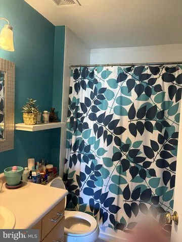 a room with a black white checkered floor and a sink