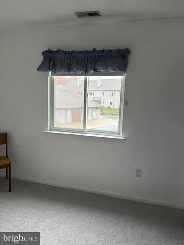 a living room with furniture a rug and a flat screen tv