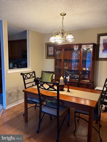a living room with furniture a flat screen tv and kitchen view