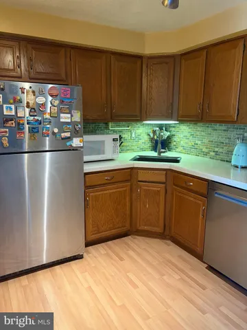 a kitchen with stainless steel appliances granite countertop a refrigerator sink and cabinets
