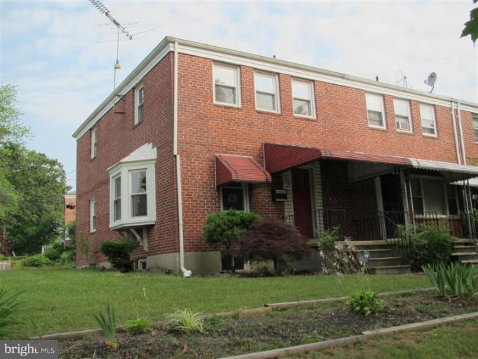 5900 Hillen Road Baltimore, MD 21239 - Photo 11 of 11 a view of a house with brick walls and a yard with plants