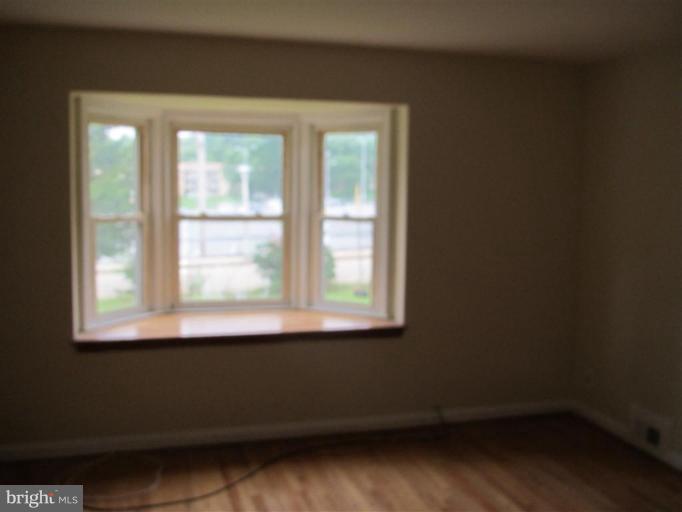 5900 Hillen Road Baltimore, MD 21239 - Photo 5 of 11 an empty room with a window