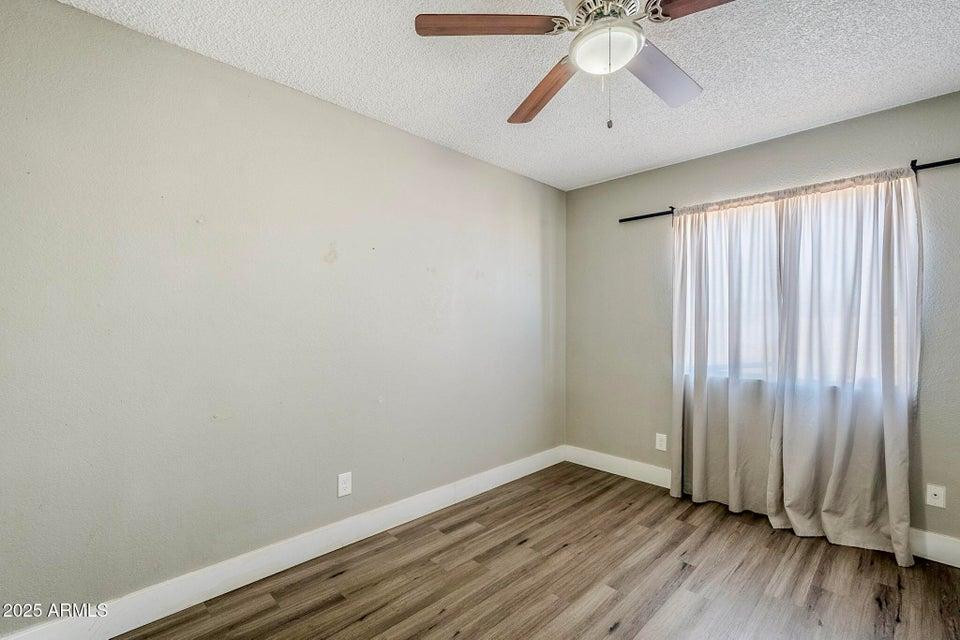1826 N Spring, Unit 201 Mesa, AZ 85203 - Photo 14 of 17 a view of wooden floor and chandelier fan in a room