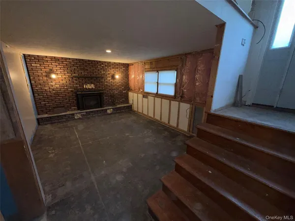 a view of entryway with wooden floor and stairs