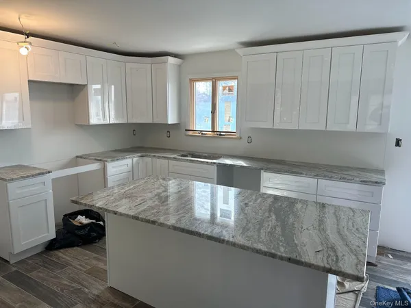 a kitchen with granite countertop cabinets stainless steel appliances and a sink