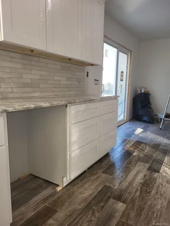 a view of an empty room with windows