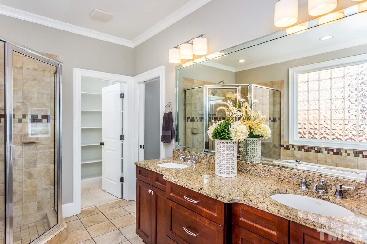 1300 Dixie Trail Raleigh, NC 27607 - Photo 12 of 24 a bathroom with a granite countertop sink a mirror a vanity and a shower
