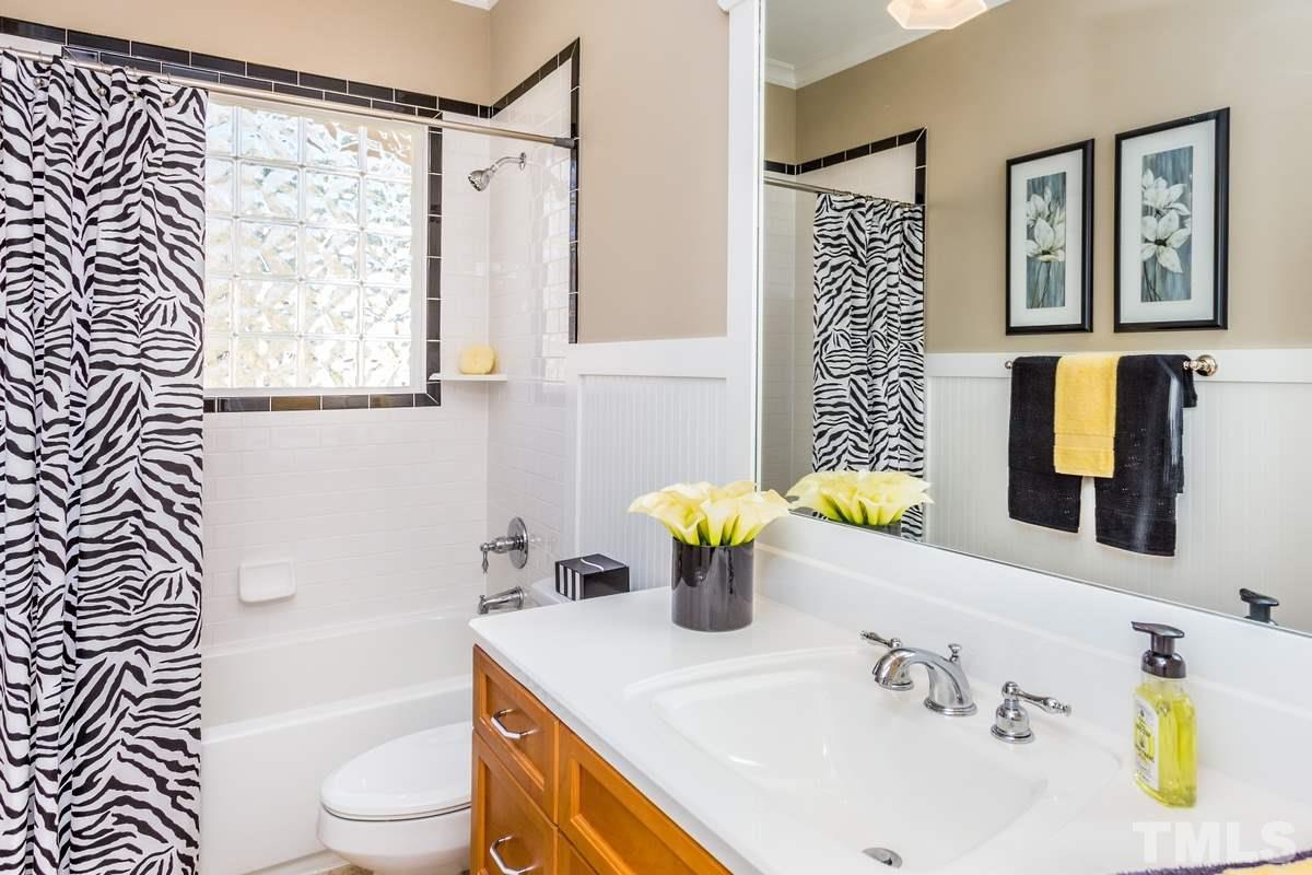 1300 Dixie Trail Raleigh, NC 27607 - Photo 17 of 24 a bathroom with a sink a toilet and shower
