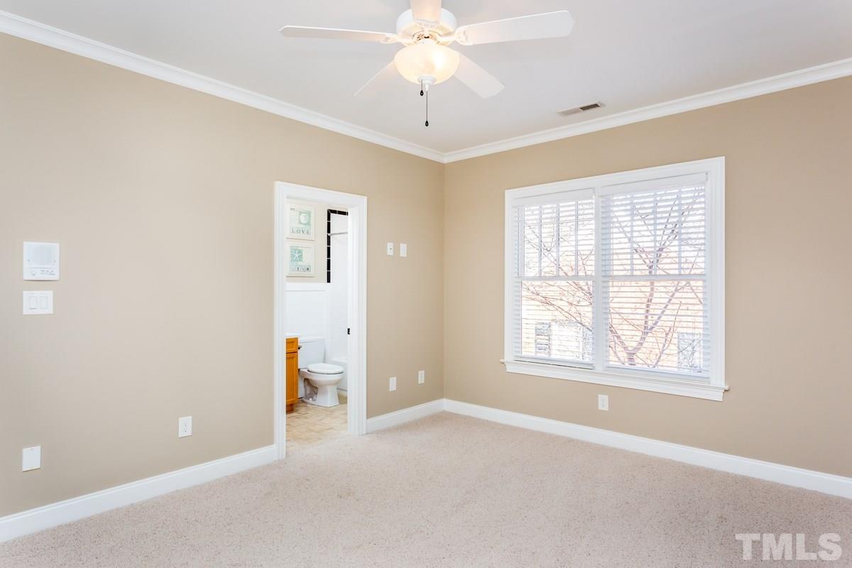 1300 Dixie Trail Raleigh, NC 27607 - Photo 18 of 24 an empty room with chandelier fan and windows