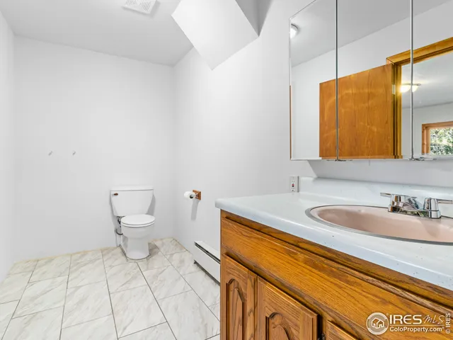 a bathroom with a sink a toilet and mirror