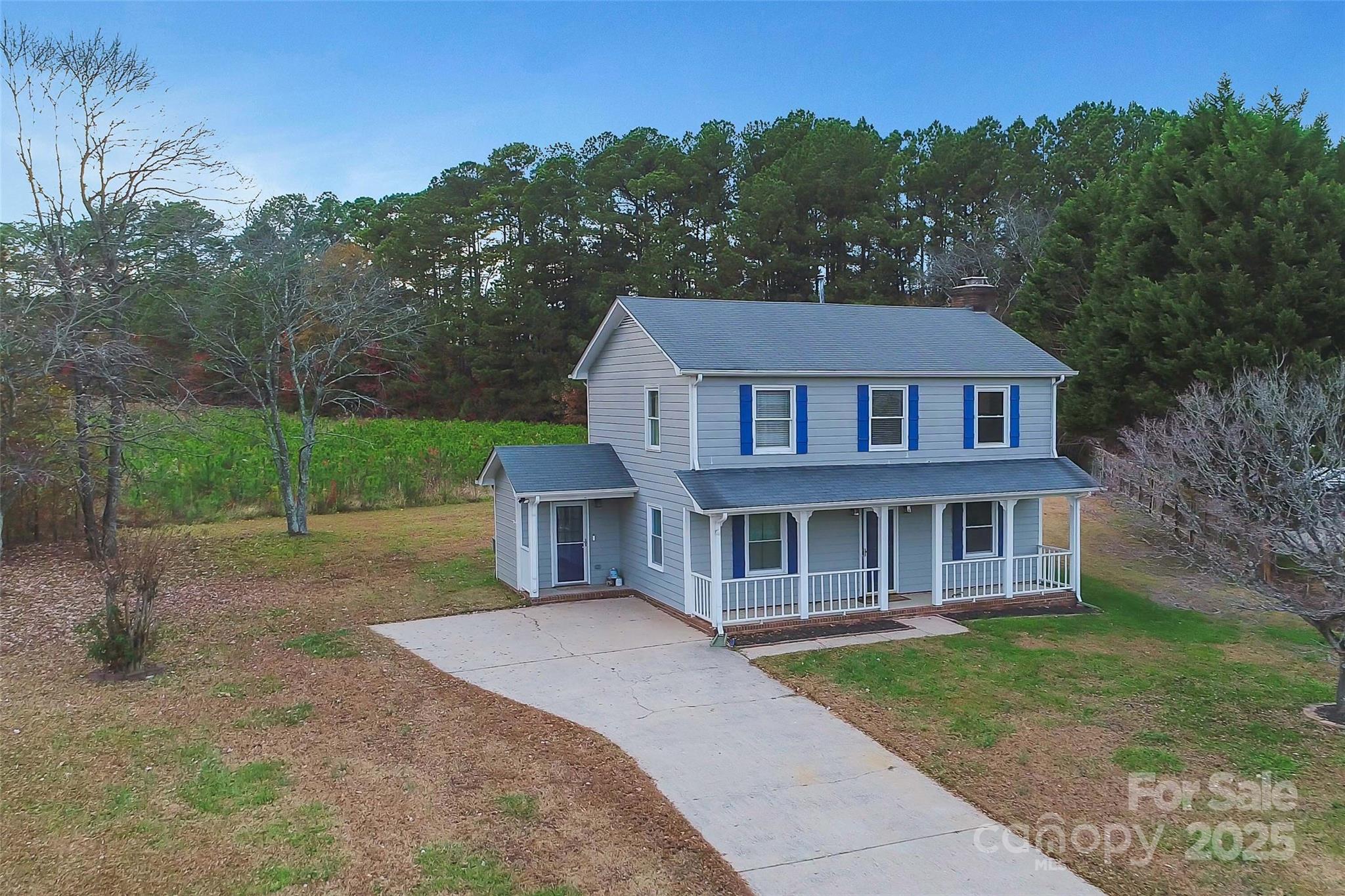 a house with green field in front of it