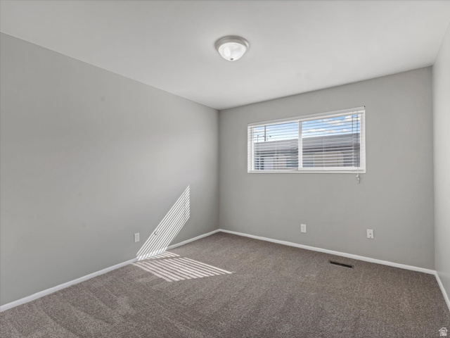 1478 North 75 West, Unit AD Sunset, UT 84015 - Photo 13 of 26 Empty room with dark carpet and baseboards