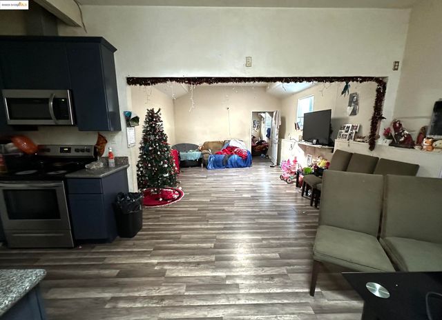 a kitchen with a dining table chairs and refrigerator