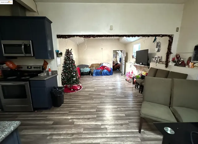 a kitchen with a dining table chairs and refrigerator