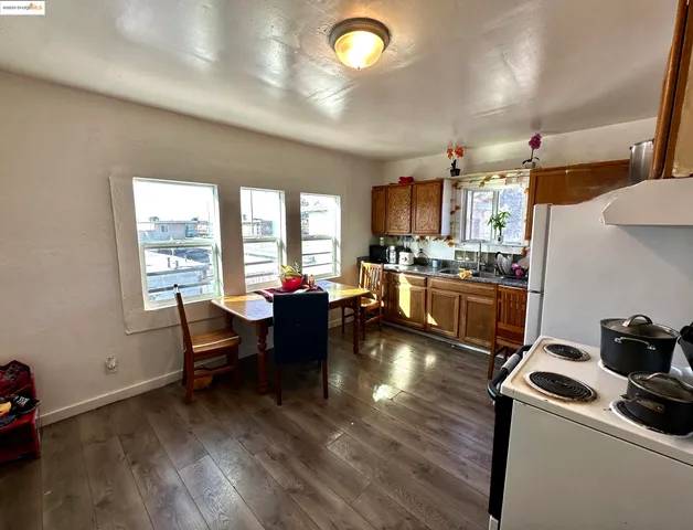 a kitchen with a granite countertop sink stove and cabinets