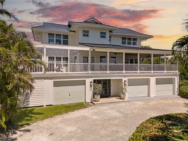 a front view of a house with a yard and a garage
