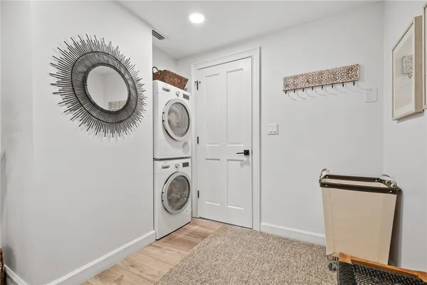 a view of a kitchen with a sink and dishwasher a stove top oven with wooden floor