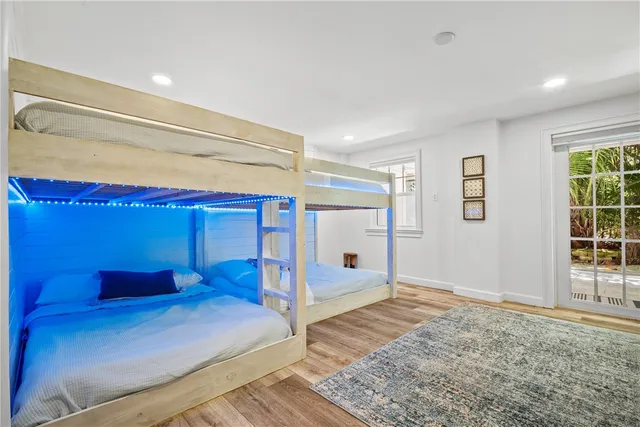 a view of a bedroom with furniture and window