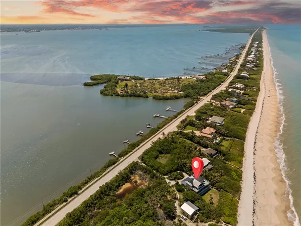 an aerial view of a houses with ocean view