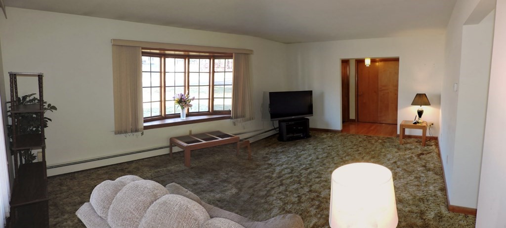 110 Gore Road Webster, MA 01570 - Photo 12 of 42 a room with furniture a flat screen tv and a fireplace