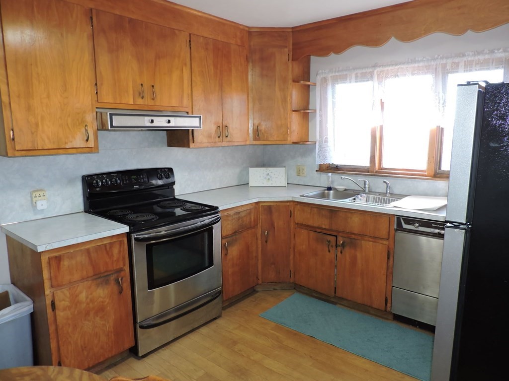 110 Gore Road Webster, MA 01570 - Photo 18 of 42 a kitchen with granite countertop a sink a stove and cabinets