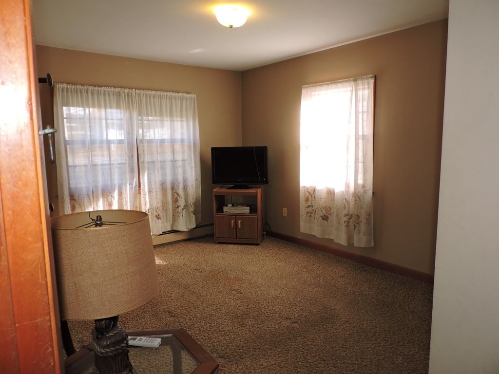 110 Gore Road Webster, MA 01570 - Photo 28 of 42 a living room with furniture and a flat screen tv