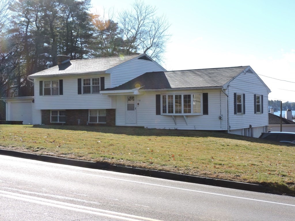 110 Gore Road Webster, MA 01570 - Photo 3 of 42 a front view of a house with a yard