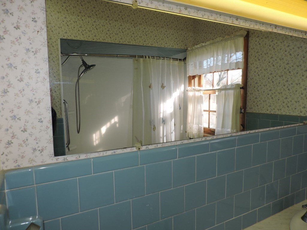 110 Gore Road Webster, MA 01570 - Photo 32 of 42 a bathroom with a glass door shower and a mirror