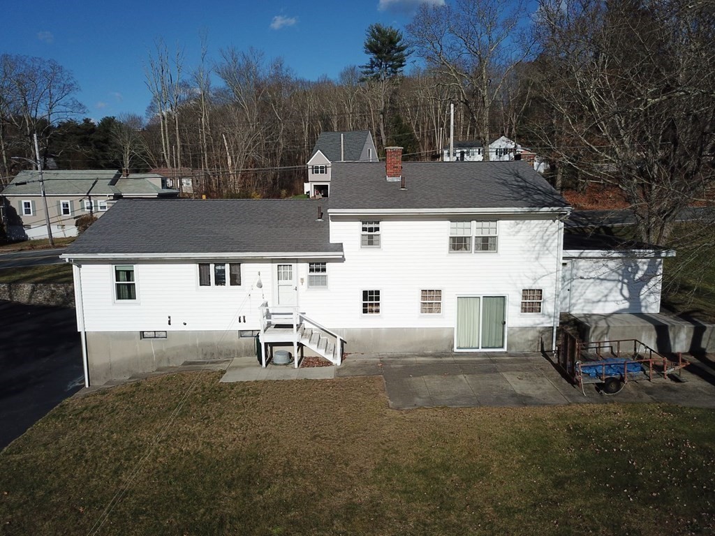 110 Gore Road Webster, MA 01570 - Photo 6 of 42 a view of a white house in a back yard