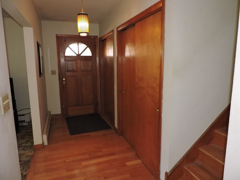 110 Gore Road Webster, MA 01570 - Photo 9 of 42 a view of a hallway with wooden floor and staircase