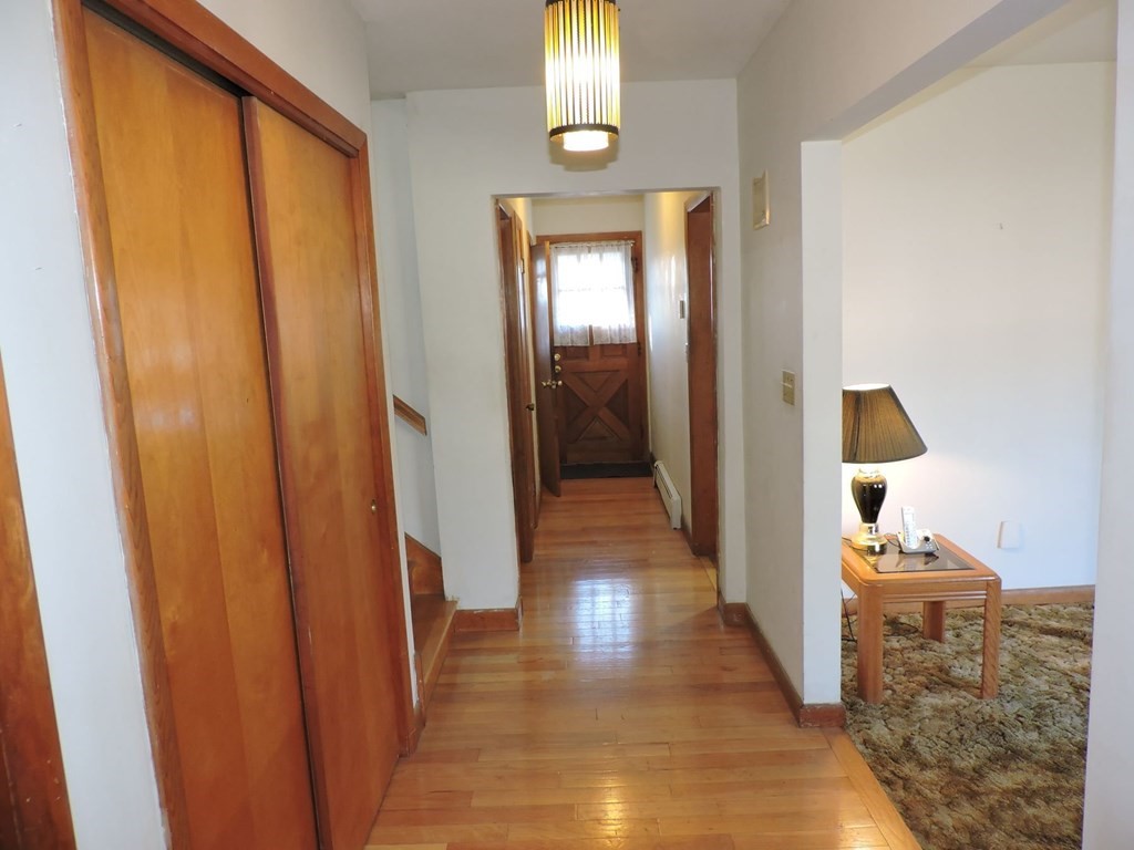 110 Gore Road Webster, MA 01570 - Photo 10 of 42 a view of a hallway with wooden floor and staircase