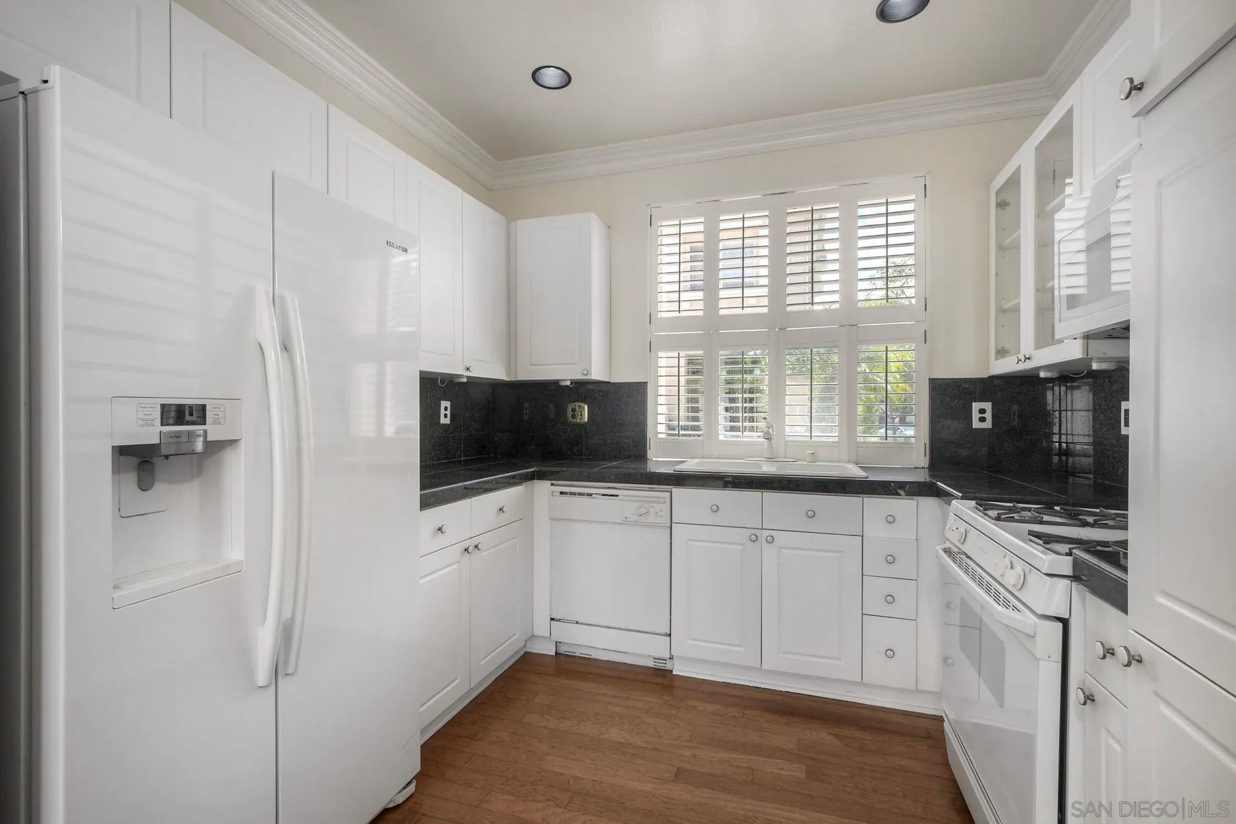 9633 Stonecrest Boulevard San Diego, CA 92123 - Photo 15 of 45 a kitchen with a sink a window and appliances