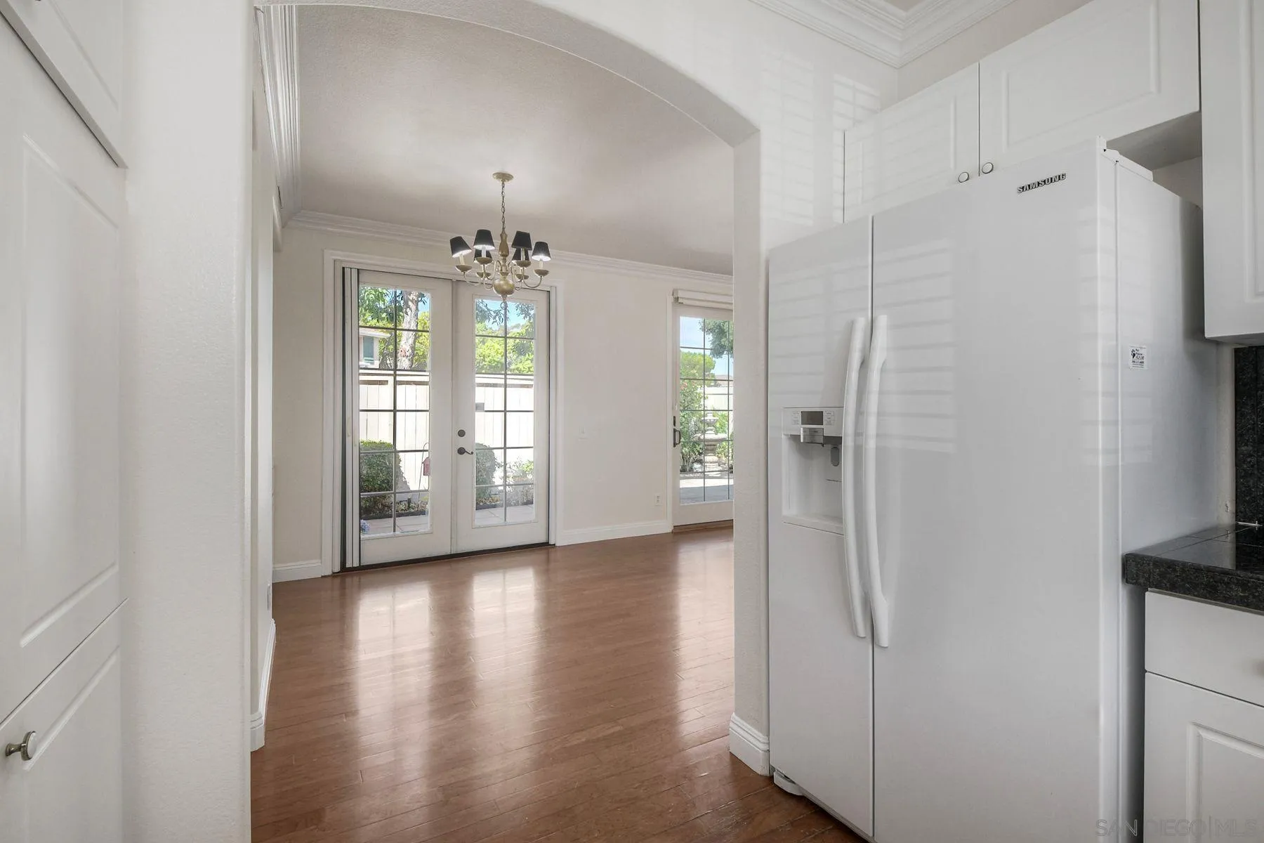 9633 Stonecrest Boulevard San Diego, CA 92123 - Photo 17 of 45 a view of a hallway with wooden floor and a dining room