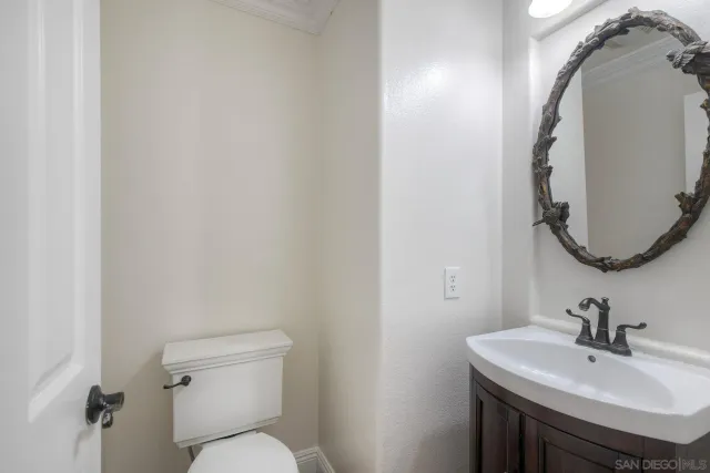 a bathroom with a sink mirror and toilet
