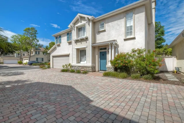 a front view of a house with a yard and a garage