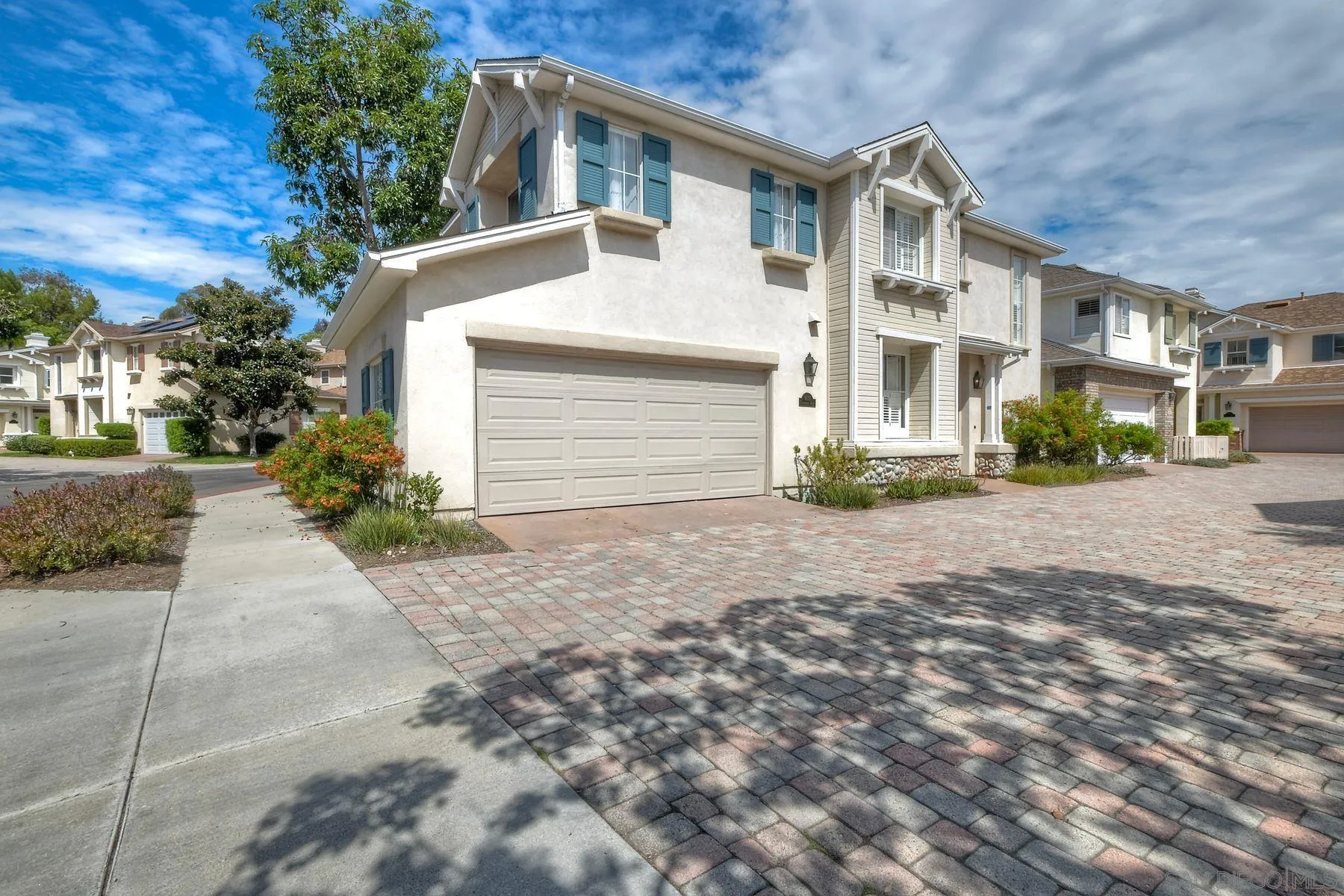 9633 Stonecrest Boulevard San Diego, CA 92123 - Photo 3 of 45 a front view of a house with a yard and garage