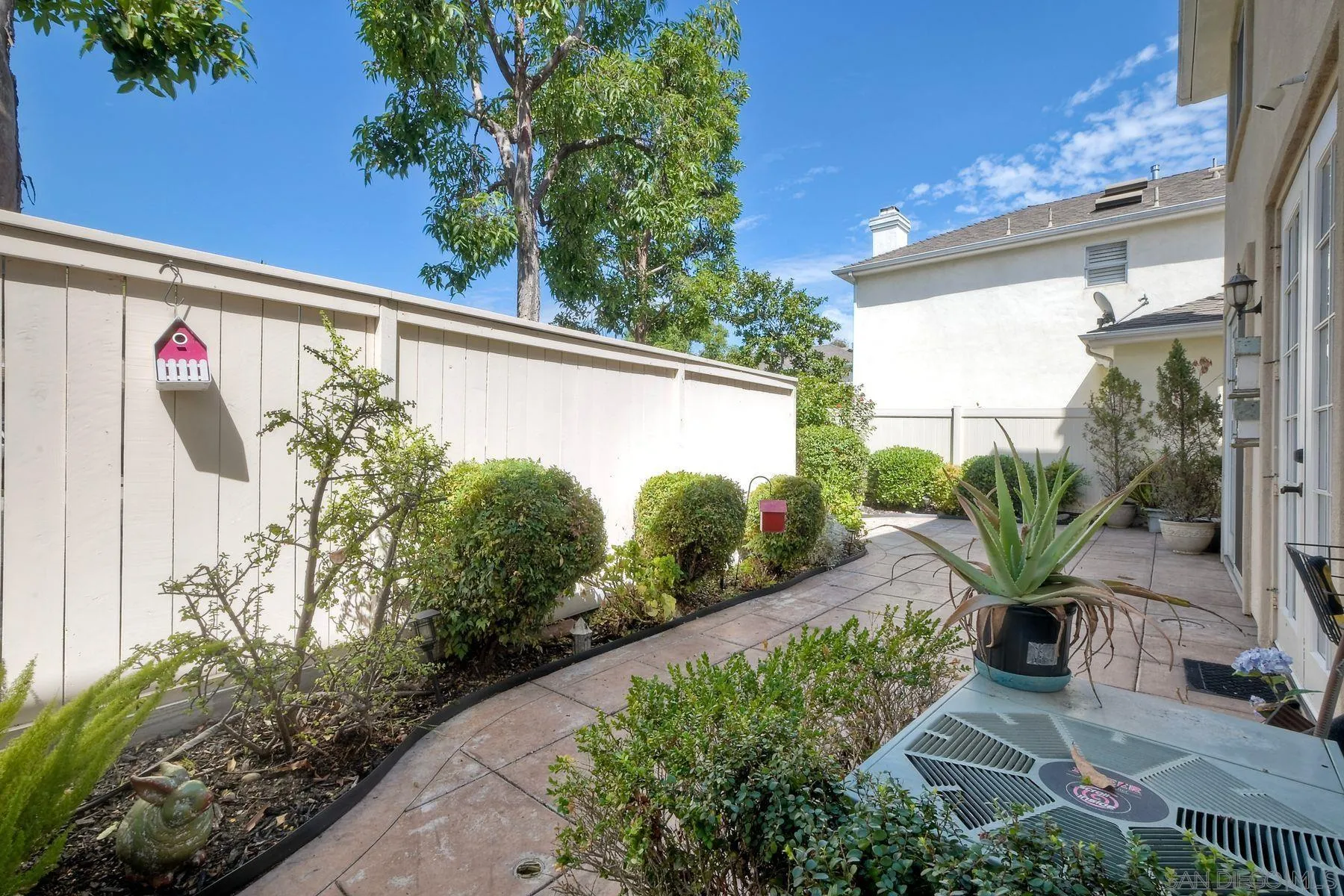 9633 Stonecrest Boulevard San Diego, CA 92123 - Photo 33 of 45 a front view of a house with garden