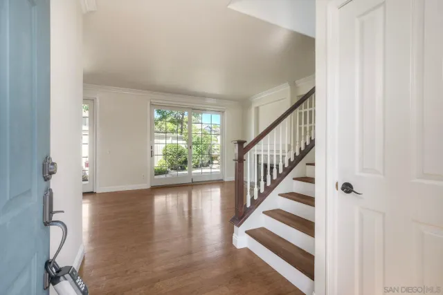 a view of entryway with wooden floor and stairs
