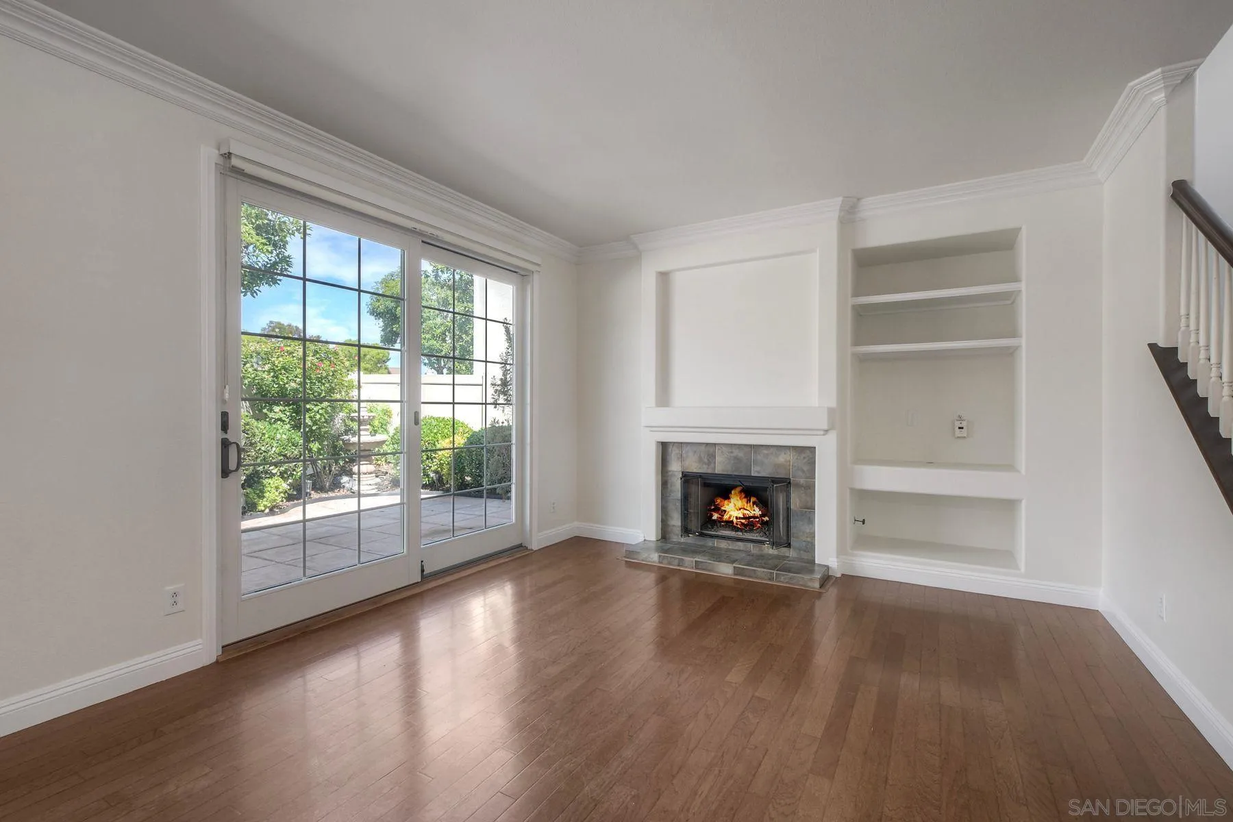 9633 Stonecrest Boulevard San Diego, CA 92123 - Photo 7 of 45 wooden floor fireplace and windows in an empty room