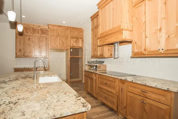 a kitchen with stainless steel appliances kitchen island granite countertop a sink and cabinets