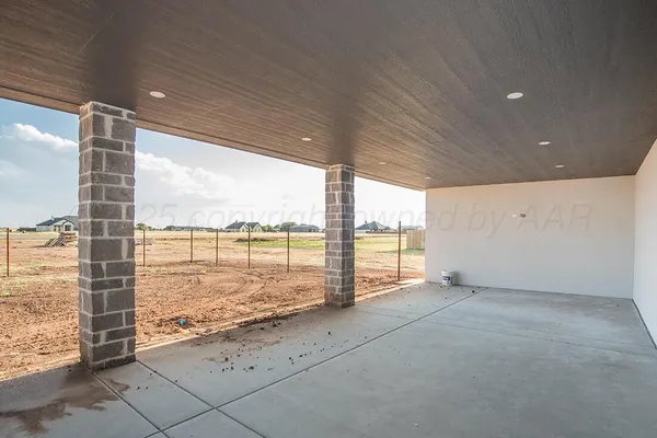an empty room with outdoor view and large trees