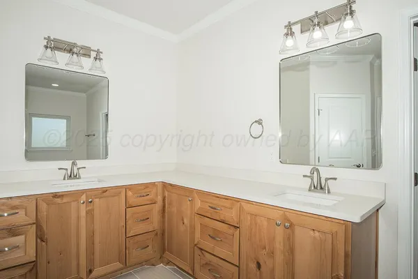 a bathroom with a double vanity sink mirror and