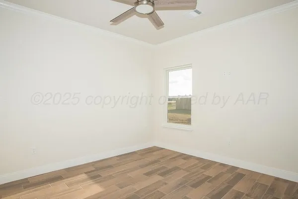 an empty room with a window and wooden floor