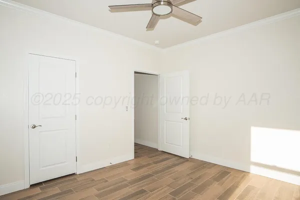 a view of an empty room with wooden floor