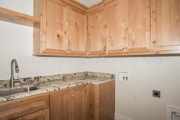 a kitchen with granite countertop white cabinets and sink