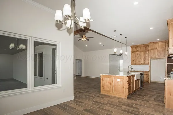 a view of a kitchen with cabinets and wooden floor
