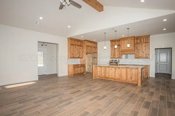 a large kitchen with a lot of counter space and stainless steel appliances