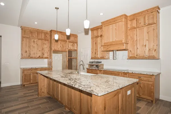 a kitchen with stainless steel appliances granite countertop a sink and cabinets