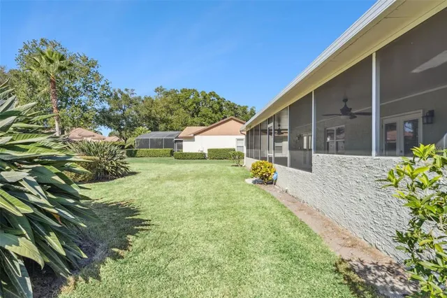 a view of a house with backyard and sitting area
