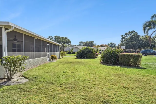a view of backyard with seating area and green space
